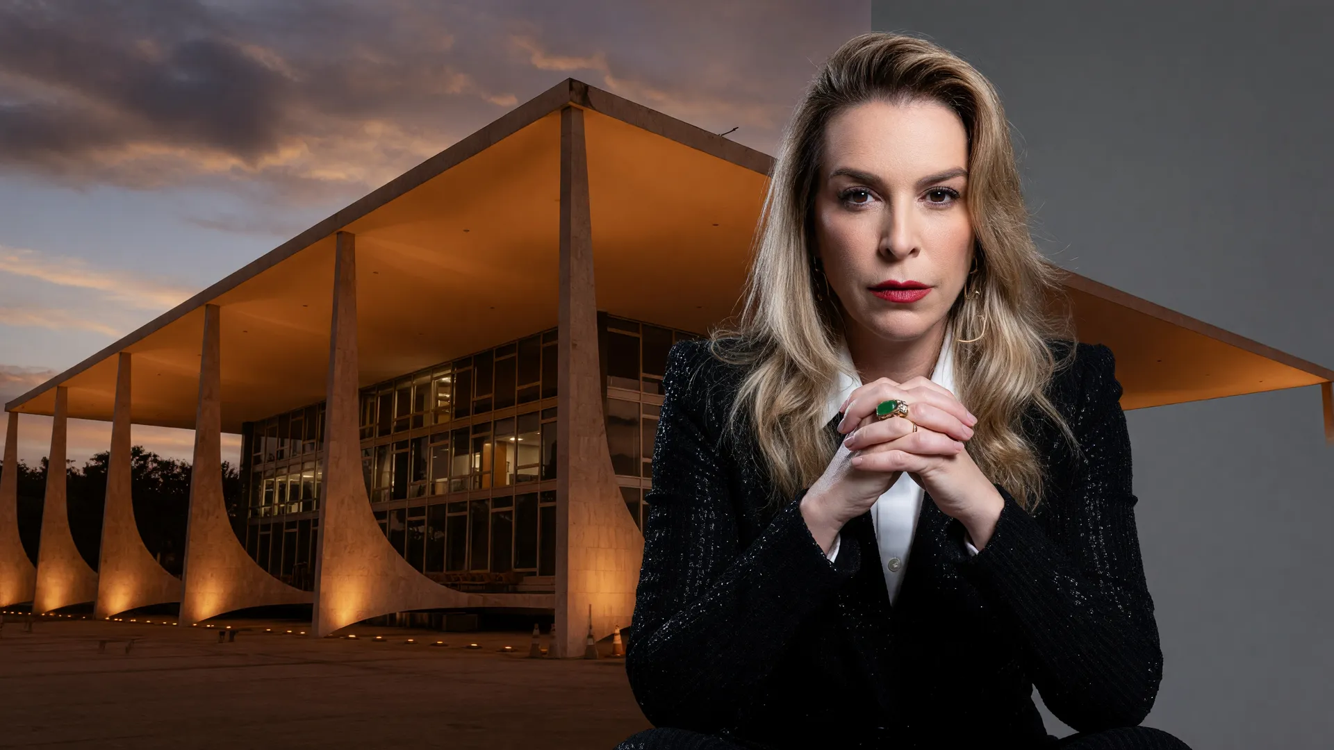 Roberta Luchsinger em close-up com terno escuro e camisa branca, fundo cinza, com a fachada icônica do STF ao fundo em tom bronze