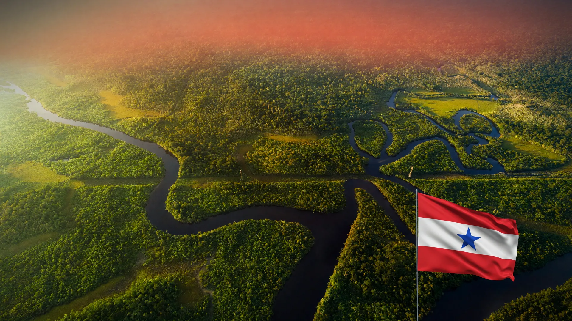 Vista aérea da Amazônia com névoa alaranjada, representando os focos de incêndio no Brasil em setembro de 2025